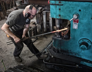 James Price forging on a power hammer