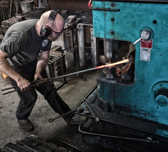 James Price forging on a power hammer