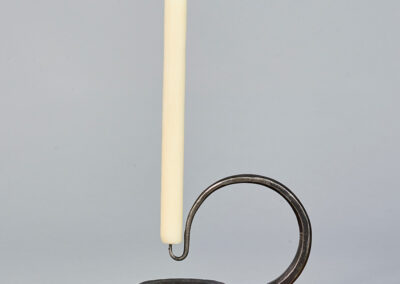 iron forged candlestick with a looped handle in a modern and contemporary design