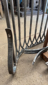 curved ends of a hand forged gothic arch railing