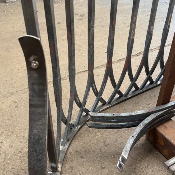 curved ends of a hand forged gothic arch railing