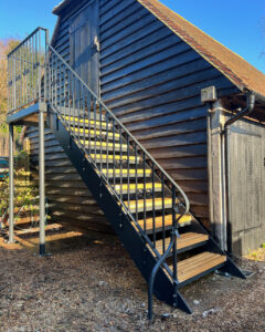 bespoke ironwork staircase with oak treads for a sussex barn