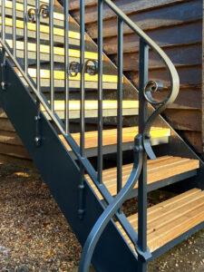 hand forged details on a wrought iron staircase for a barn