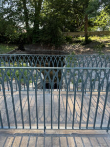 Gothic arch wrought iron railing in a Sussex garden