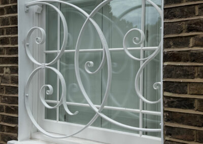 hand forged scroll work on a new security grill for a georgian house in Primrose Hill