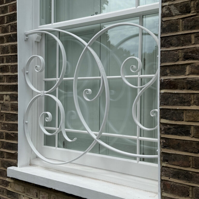 hand forged scroll work on a new security grill for a georgian house in Primrose Hill