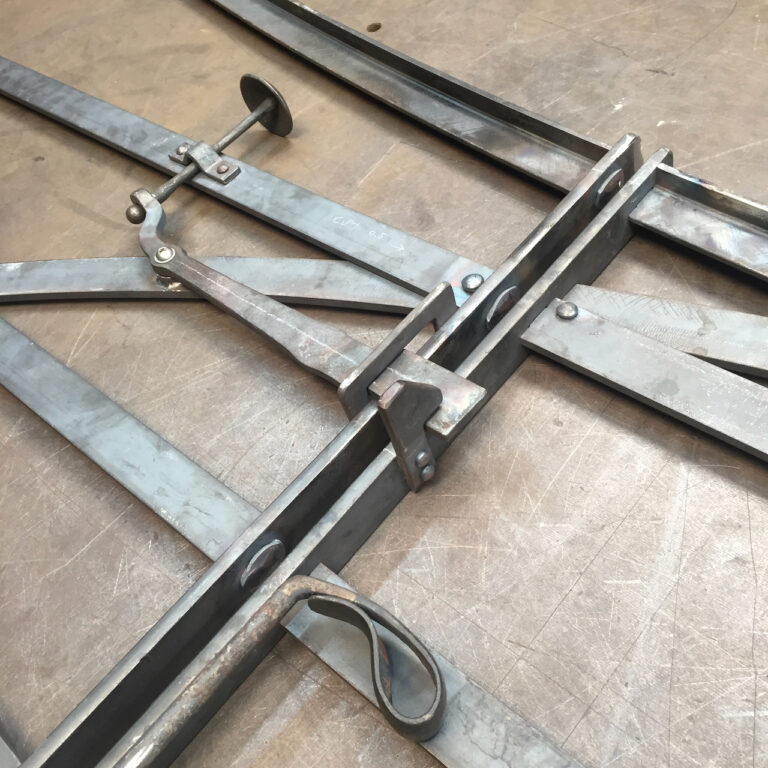 Hand forged latch detail on an estate gate with rivets