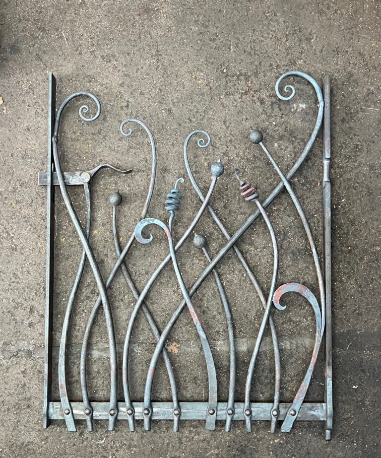 Organic scroll gate in hand forged iron with a design of seed heads and plant details