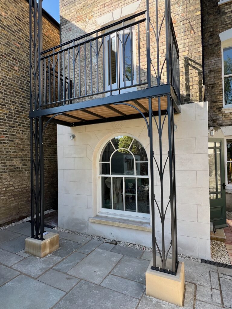 custom wrought iron balcony and veranda with an oak deck on a victorian house in kent