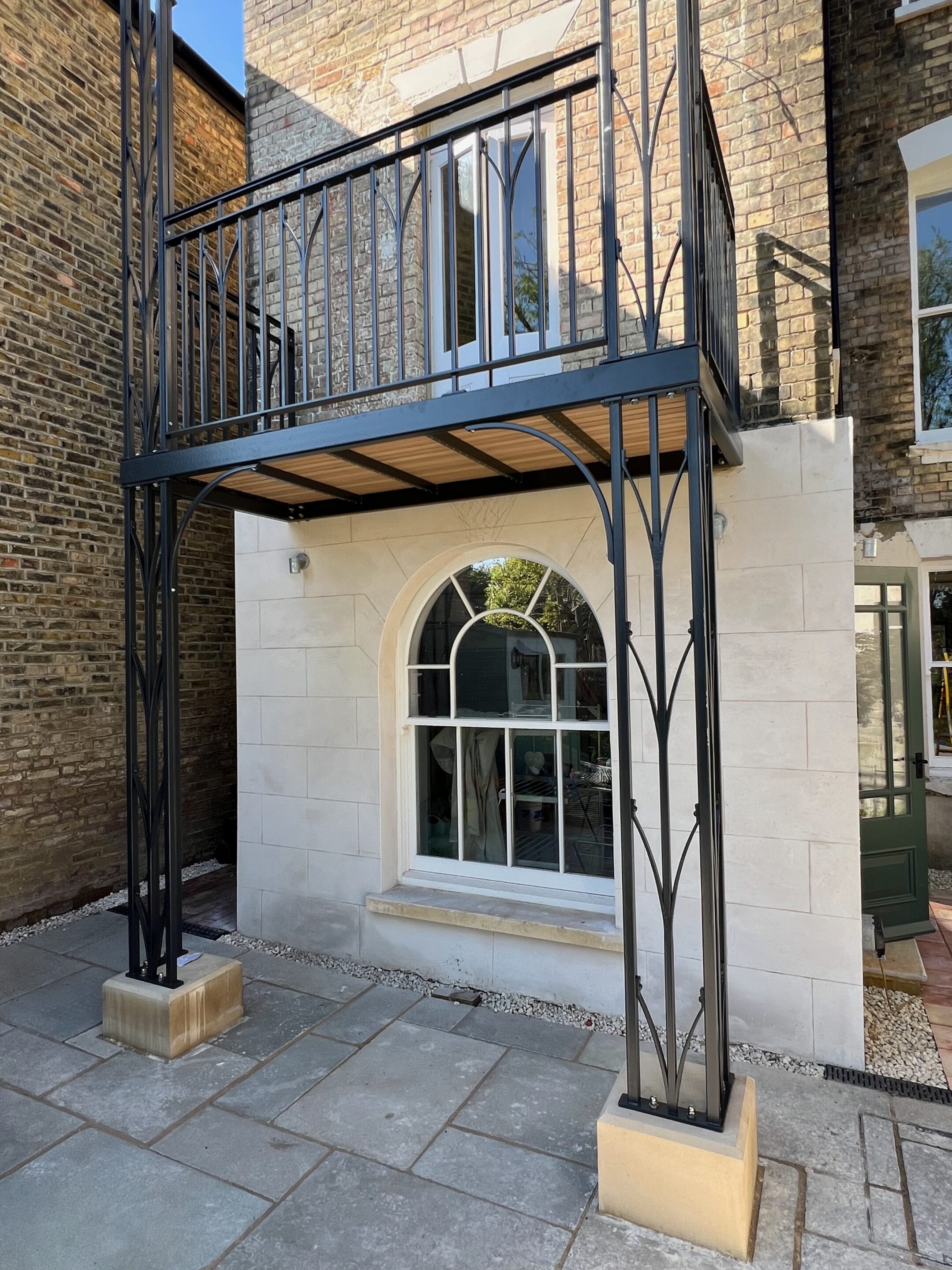 custom wrought iron balcony and veranda with an oak deck on a victorian house in kent