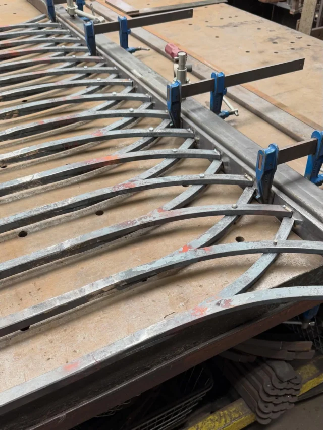 Rivets and a bit of Tig…… finally beginning the assembly of these railing panels with swept curved ends. These forge welded railings have been commissioned for @gatewick_gardens in West Sussex , eventually these will be galvanised painted a rather lovely shade of blue. As ever an understated classically inspired design doesn’t mean a simple construction. Details are everything. Resolving the joins on these took a bit of head scratching but we got there 👌🏼